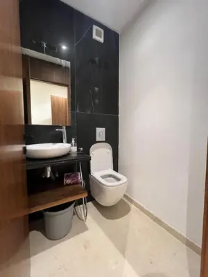 a bathroom with a toilet and a sink at Casablanca Finance City 33 Tower in Casablanca