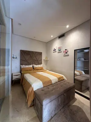 a large bedroom with a large bed and a couch at Urban flat Bourgogne in Casablanca