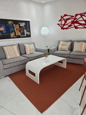 a living room with a couch and a coffee table at Tounarouz Studio in Casablanca