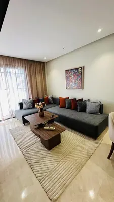 a living room with a couch and a table at Studio Iza 08 CFC à 2mn in Casablanca