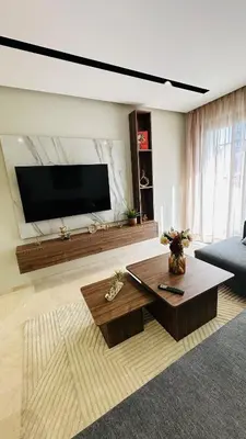 a living room with a tv and a coffee table at Studio Iza 08 CFC à 2mn in Casablanca