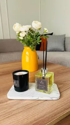 a table with a candle and a vase with flowers at Studio le César 6 CFC 2 minutes away in Casablanca