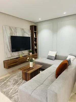 a living room with a couch and a flat screen tv at Studio New York 1 CFC 2 minutes away in Casablanca