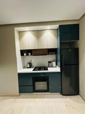 a kitchen with blue cabinets and a refrigerator at Studio New York 1 CFC 2 minutes away in Casablanca