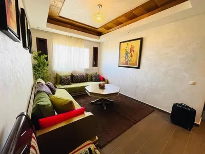 a living room with a couch and a table at Janat KLK, tamaris beach in Tamaris