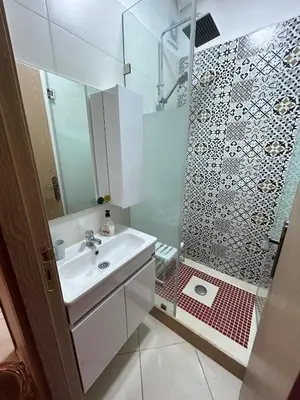 a bathroom with a sink and a shower at Modern apartment in Skhirat 5 minutes from the beach in Skhirat