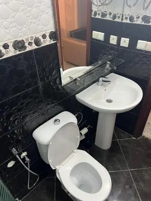 a bathroom with a toilet and a sink at Spacious apartment beachfront city center in Casablanca