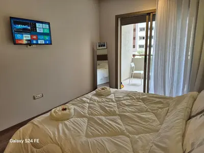 a bedroom with a bed with a tv on the wall at aeroperla 15 aéroport casa blanca in Nouaseur