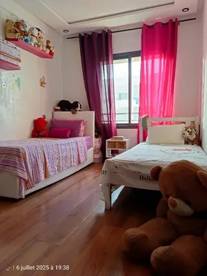 a childs bedroom with two beds and a teddy bear at Appart Haut Standing, Très Calm à Nouaceur, Parking, Piscine, à 4min de l'Aéroport in Casablanca