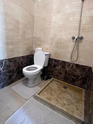 a bathroom with a toilet and a shower at Vue mer, confort, plage à 10 min in Sidi Rahal