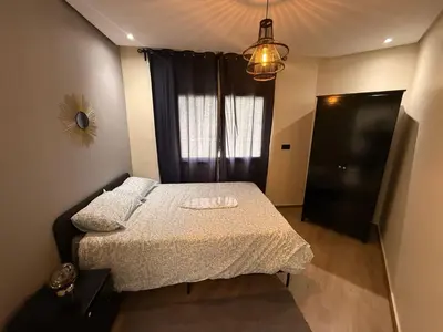 a small bedroom with a bed and a window at Elegance & Comfort - by Nero in Casablanca