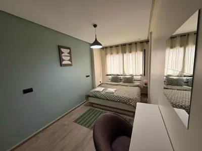 a small room with two beds and a mirror at Elegance & Comfort - by Nero in Casablanca