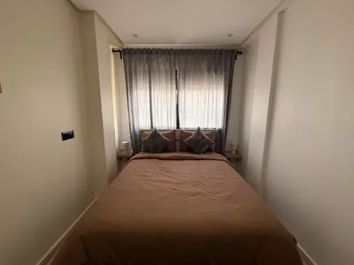 a small bedroom with a bed in front of a window at Urban Loft - by Nero in Casablanca