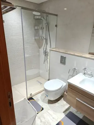 a bathroom with a shower and a toilet and a sink at L'Écume Des Sablettes in Mohammedia