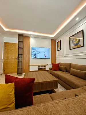 a living room with a couch and a table at L'Écume Des Sablettes in Mohammedia