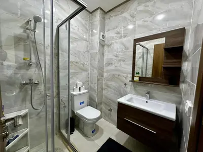 a bathroom with a shower and a toilet and a sink at APT Luxueux à Costa Beach 3 avec Piscine et accès Plage in Bouznika