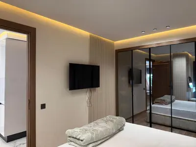 a bedroom with a bed with a television on the wall at Joli Studio with Seaview 16 in Casablanca