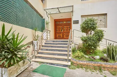 a set of stairs leading to a wooden door at 2BR Getaway Near and Seaside Promenade in Casablanca