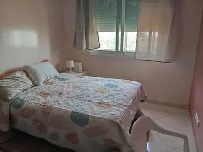 a bedroom with a bed and a window at Sara Appartement in Casablanca