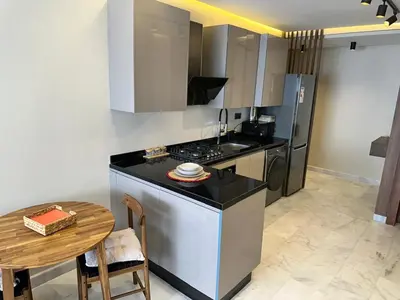a kitchen with a counter and a table and a stove at Harmonie Elitaire in Casablanca