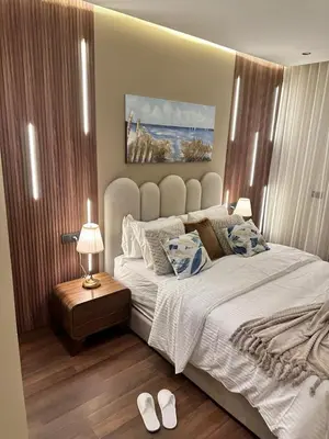 a bedroom with a large bed and a pair of white shoes at Harmonie Elitaire in Casablanca