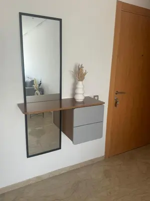 a mirror on a wall with a vase on a shelf at Appart idéal Face Gare Agdal in Rabat