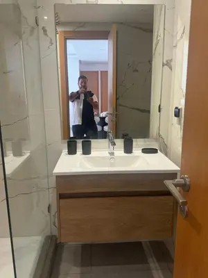 a man taking a picture of himself in a bathroom mirror at Appart idéal Face Gare Agdal in Rabat