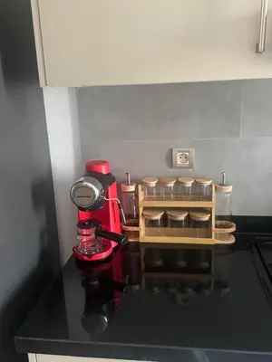 a kitchen counter with a red mixer on a counter top at Appart idéal Face Gare Agdal in Rabat