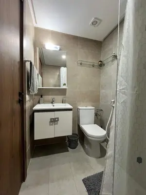 a bathroom with a toilet and a sink and a shower at Appartement cosy et confortable in Casablanca
