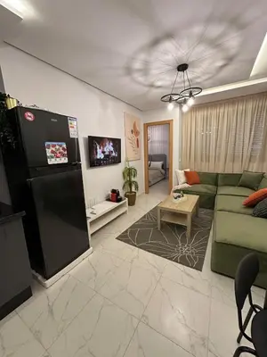 a living room with a couch and a refrigerator at Chic Studio In The Heart of Casablanca Morocco in Casablanca