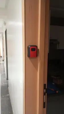 a red and black door knob on a wooden door at Chic Studio In The Heart of Casablanca Morocco in Casablanca