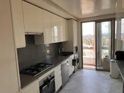 a kitchen with a stove and a counter top at Grand appartement la corniche vue panoramique sur Casablanca in Casablanca