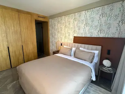 a bedroom with a large bed and a wall at Premium Stay - Opale Seaside Beachfront in Anfa-Supérieur