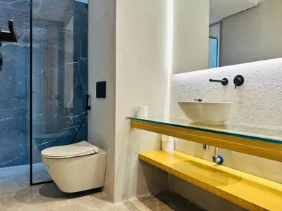 a bathroom with a toilet and a sink and a shower at Premium Stay - Opale Seaside Beachfront in Anfa-Supérieur