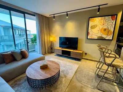 a living room with a couch and a tv at Premium Stay - Opale Seaside Beachfront in Anfa-Supérieur