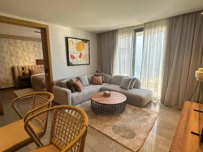a living room with a couch and a table at Premium Stay - Opale Seaside Beachfront in Anfa-Supérieur