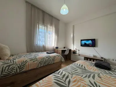 a bedroom with two beds and a flat screen tv at studio ensoleillé á louer Témara, in Temara