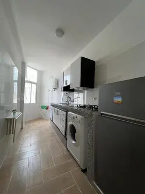 a kitchen with a washer and dryer in it at studio ensoleillé á louer Témara, in Temara