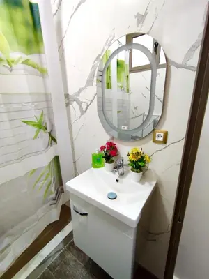 a bathroom with a sink and a mirror at Hideaway Rosa Parc Mohammedia in Mohammedia
