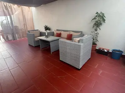 a living room with a couch and a table at Hideaway Rosa Parc Mohammedia in Mohammedia