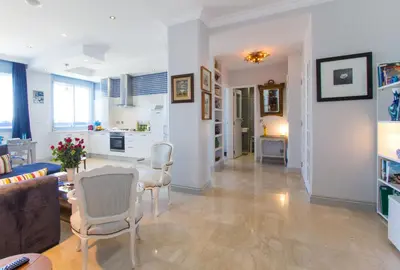 a living room with a couch and a table and chairs at Appartement Lilia in Casablanca