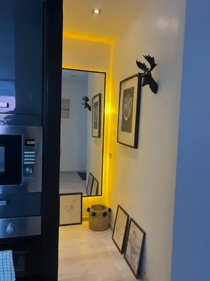 a hallway with a wall with pictures and a mirror at Stay IN GAUTHIER studio M in Casablanca