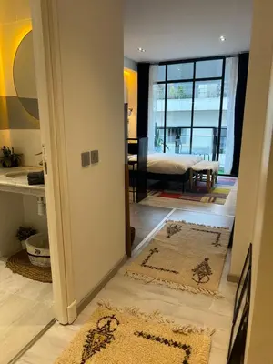 a room with two rugs on the floor and a bedroom at Stay In GAUTHIER studio s in Casablanca