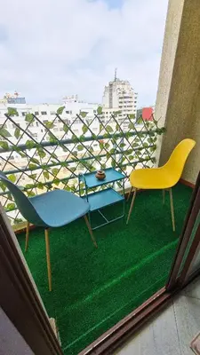 two chairs and a table on a balcony at appartement central in Casablanca