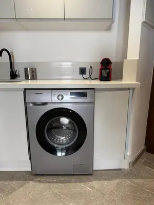 a washing machine under a counter in a kitchen at Adresse remarquable casablanca in Casablanca