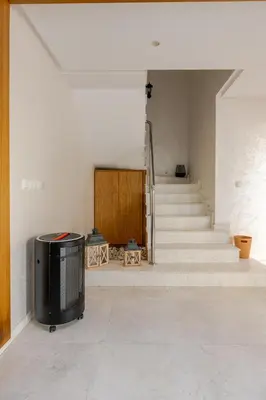 a living room with stairs and a tv in a room at Villa Evasion Rabat Beach in Rabat