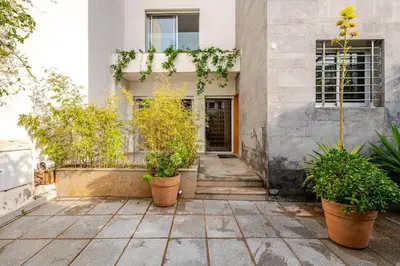 a building with potted plants in front of it at Villa Evasion Rabat Beach in Rabat
