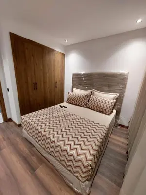 a bedroom with a large bed with a wooden headboard at Luxurious Studio in Casablanca in Casablanca