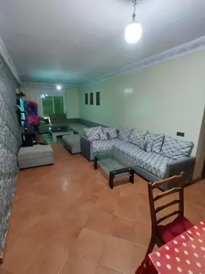 a large living room with couches and a table at AZEMMOUR appart in Azemmour