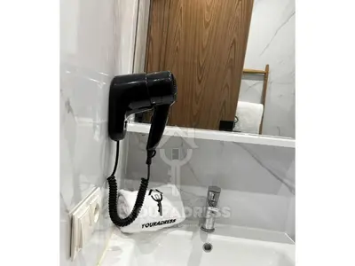 a black phone sitting on a bathroom sink at Youradress Casablanca - Maarif in Casablanca